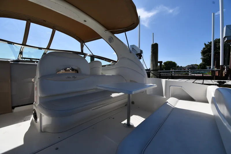 Slide: The Image of Interior view of a 2002 Sea Ray 360 Sundancer yacht with white seating and table. - 13