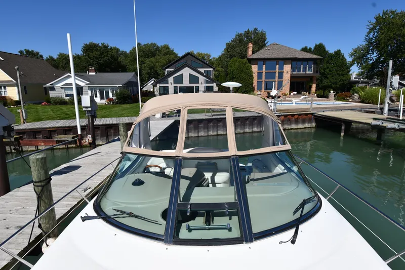 Slide: The Image of 2002 Sea Ray 360 Sundancer docked near waterfront homes on a sunny day. - 7