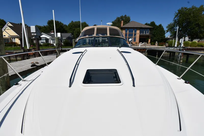 Slide: The Image of 2002 Sea Ray 360 Sundancer yacht docked at marina, sunny day, waterfront homes in background. - 6
