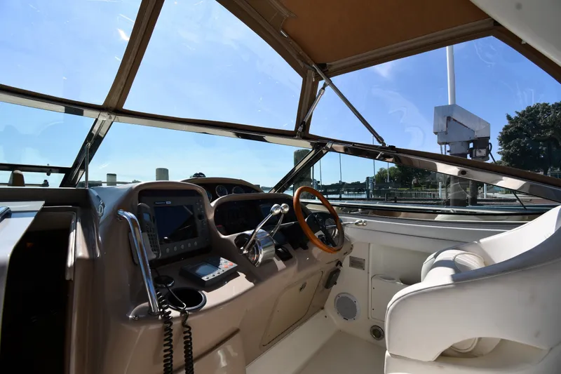 Slide: The Image of Cockpit of 2002 Sea Ray 360 Sundancer with steering wheel and navigation equipment. - 10