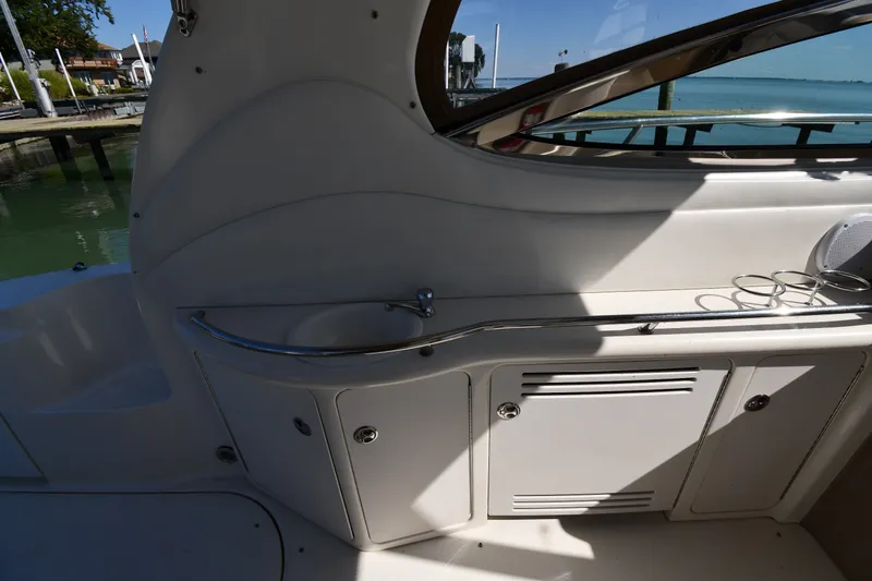 Slide: The Image of 2002 Sea Ray 360 Sundancer boat interior with sink and storage compartments. - 18