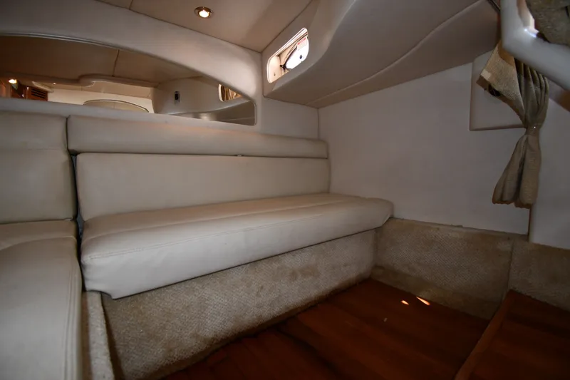 Slide: The Image of Interior cabin of 2002 Sea Ray 360 Sundancer with beige seating and wood flooring. - 37