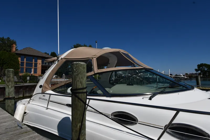 Slide: The Image of 2002 Sea Ray 360 Sundancer yacht docked at marina under clear blue sky. - 3
