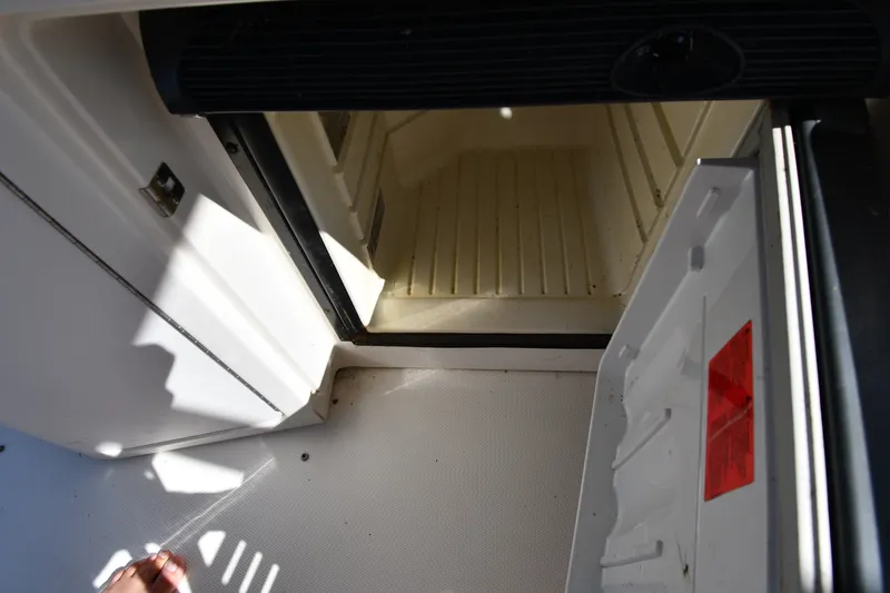 Slide: The Image of Open hatch on 2002 Sea Ray 360 Sundancer boat, showing interior compartment. - 19