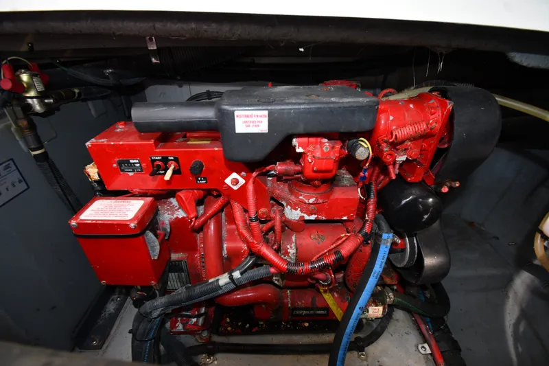 Slide: The Image of Engine compartment of a 2002 Sea Ray 360 Sundancer boat, featuring a red engine. - 43