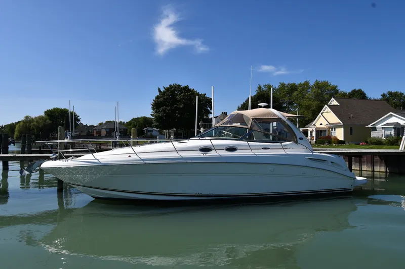 The Image of 2002 Sea Ray 360 Sundancer yacht docked in a serene marina setting. - 1