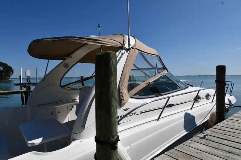 Slide: The Image of 2002 Sea Ray 360 Sundancer docked by the water on a sunny day. - 2