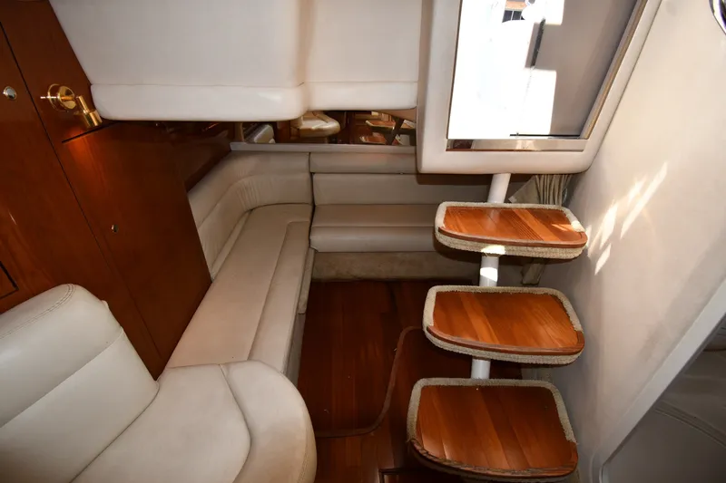 Slide: The Image of Interior of 2002 Sea Ray 360 Sundancer yacht with wooden steps and beige seating. - 34