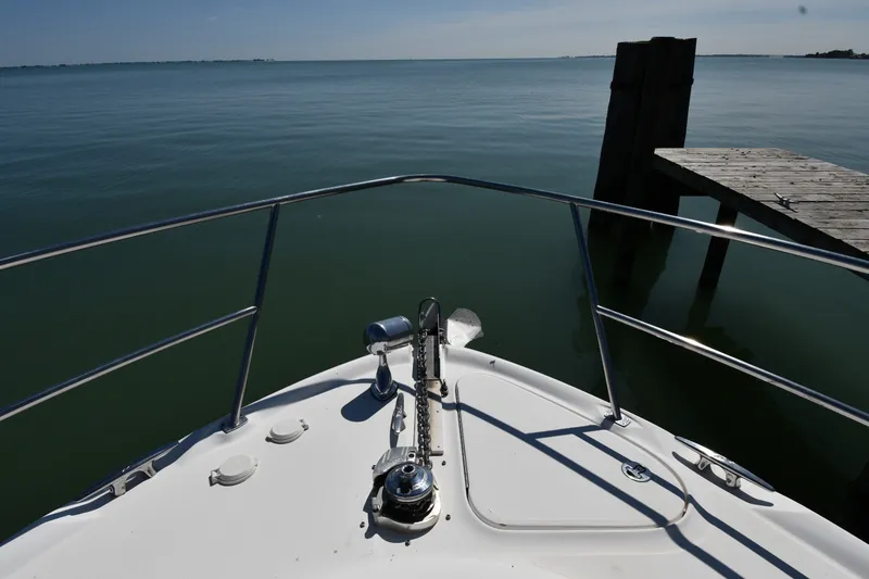 Slide: The Image of Bow view of 2002 Sea Ray 360 Sundancer near a wooden dock. - 4