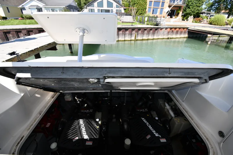 Slide: The Image of Engine compartment of a 2002 Sea Ray 360 Sundancer with Mercury engines, dockside view. - 39