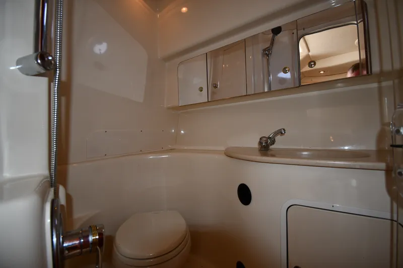 Slide: The Image of 2002 Sea Ray 360 Sundancer bathroom with sink, toilet, and storage cabinets. - 33