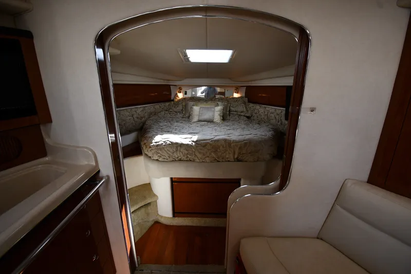 Slide: The Image of Interior of 2002 Sea Ray 360 Sundancer yacht with cozy bed and elegant wood finish. - 21