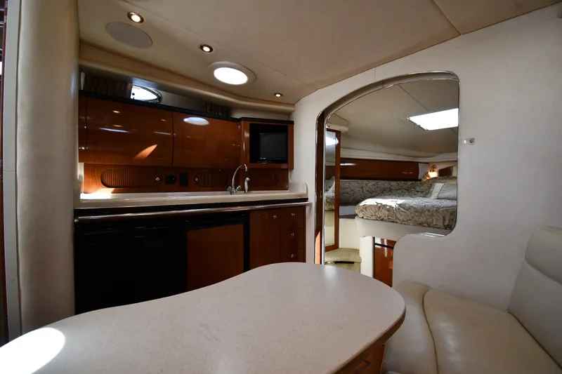 Slide: The Image of Interior of 2002 Sea Ray 360 Sundancer yacht with kitchenette and cozy sleeping area. - 26