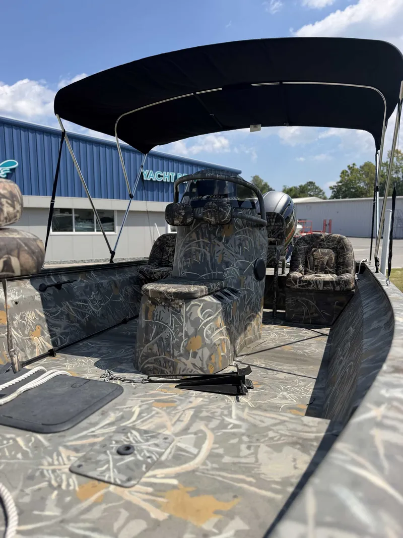 Slide: The Image of The image shows a 2023 War Eagle 2170 Blackhawk boat with camouflage pattern and sunshade. - 3