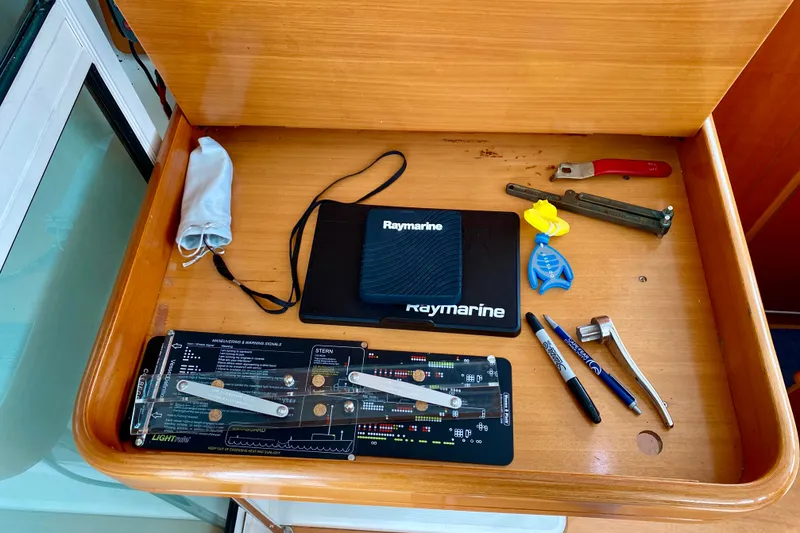 Slide: The Image of Navigation tools and equipment in a Lagoon 380 S2 yacht's wooden compartment, 2005 model. - 112