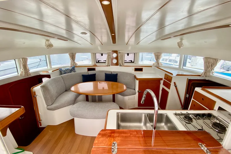 Slide: The Image of Interior of 2005 Lagoon 380 S2 catamaran with modern kitchen and cozy seating area. - 42