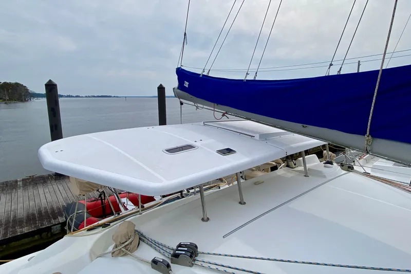 Slide: The Image of Lagoon 380 S2 catamaran, 2005 model, docked by a serene waterfront. - 21