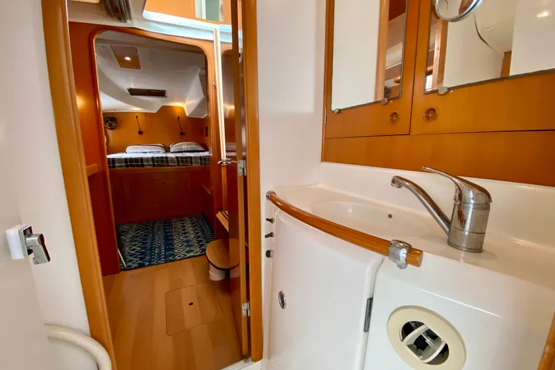 Slide: The Image of Interior of 2005 Lagoon 380 S2 yacht showing bathroom and cozy bedroom. - 77