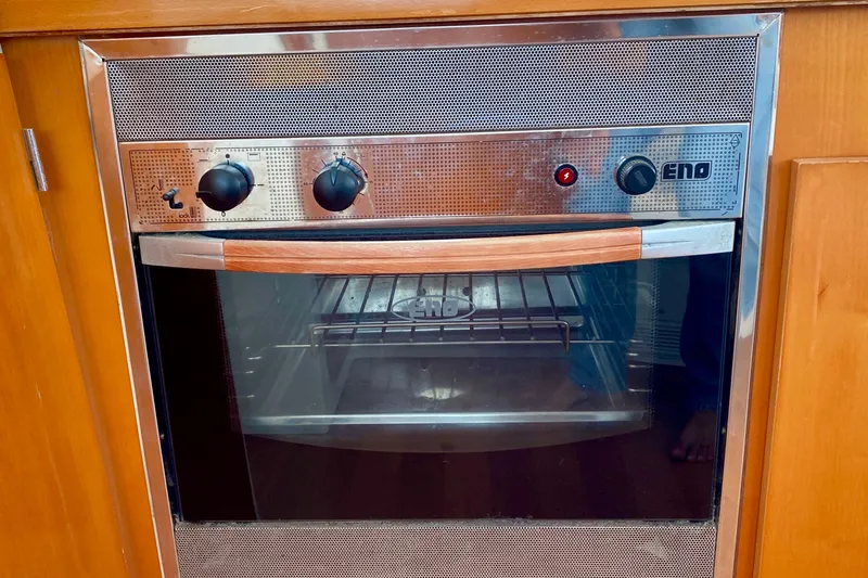 Slide: The Image of Built-in oven on Lagoon 380 S2 yacht, 2005 model, with wooden cabinetry. - 122
