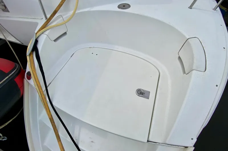 Slide: The Image of Cockpit area of a 2005 Lagoon 380 S2 catamaran, featuring clean white surfaces. - 95