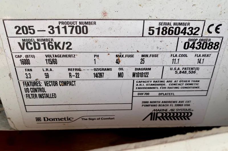Slide: The Image of Label on Dometic air conditioning unit, model VCD16K/2, showing specifications and patent details. - 140