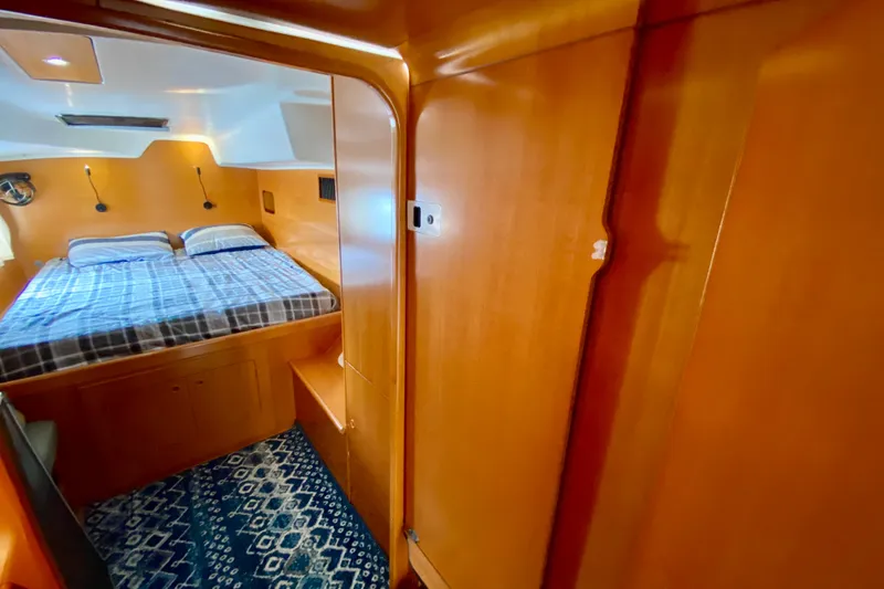 Slide: The Image of Cozy cabin interior of 2005 Lagoon 380 S2 catamaran with double bed and wooden finish. - 79