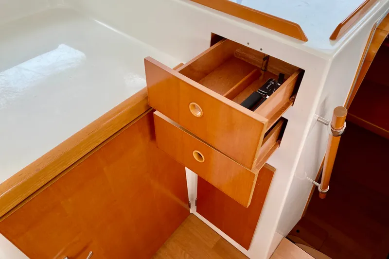 Slide: The Image of Wooden cabinetry with open drawers in a 2005 Lagoon 380 S2 yacht interior. - 128