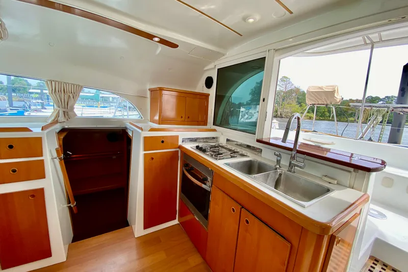 Slide: The Image of Interior of 2005 Lagoon 380 S2 yacht featuring a modern kitchen with dual sinks. - 59