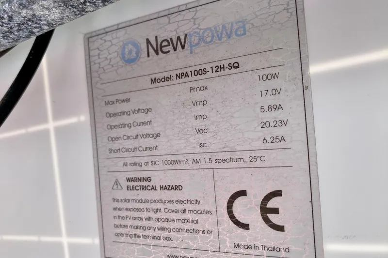 Slide: The Image of Label on Newpowa solar panel, model NPA100S-12H-SQ, showing electrical specifications and warnings. - 153