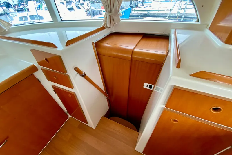 Slide: The Image of Interior view of 2005 Lagoon 380 S2 yacht with wooden cabinetry and stairs. - 67