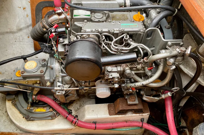 Slide: The Image of Engine compartment of a 2005 Lagoon 380 S2 catamaran, showcasing intricate mechanical components. - 105