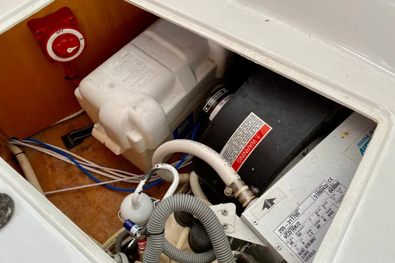 Slide: The Image of Engine compartment of a 2005 Lagoon 380 S2 catamaran, featuring battery and wiring. - 141