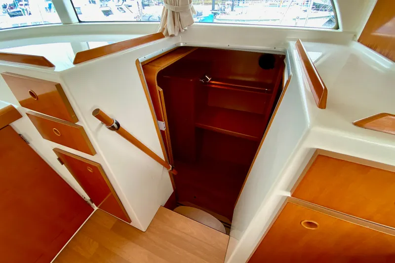 Slide: The Image of Interior view of 2005 Lagoon 380 S2 yacht with wooden cabinetry and stairs. - 66