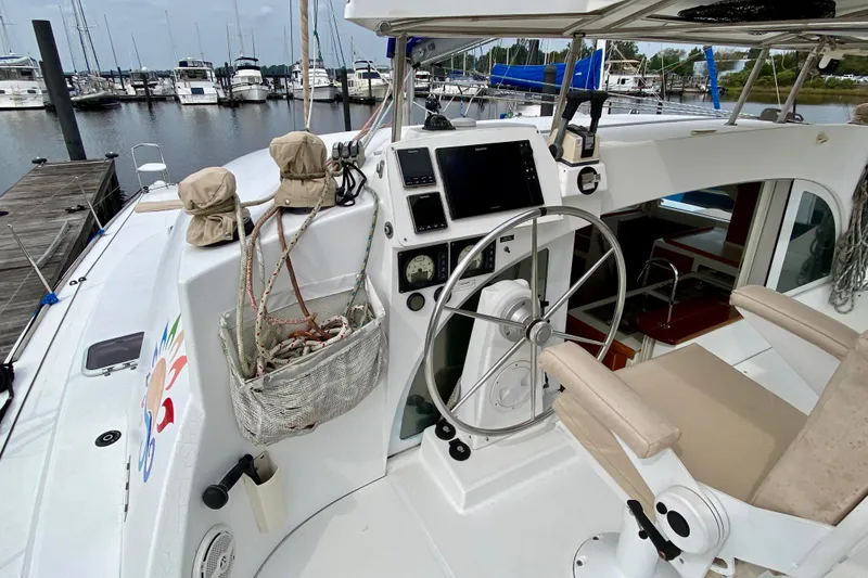 Slide: The Image of Helm of 2005 Lagoon 380 S2 catamaran docked at marina, featuring navigation equipment. - 39