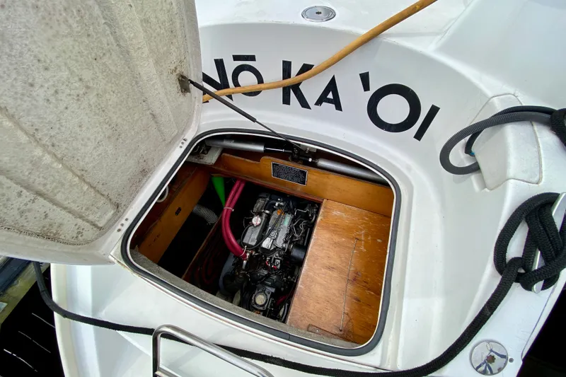 Slide: The Image of Open engine compartment of 2005 Lagoon 380 S2 catamaran, showcasing internal mechanics. - 103