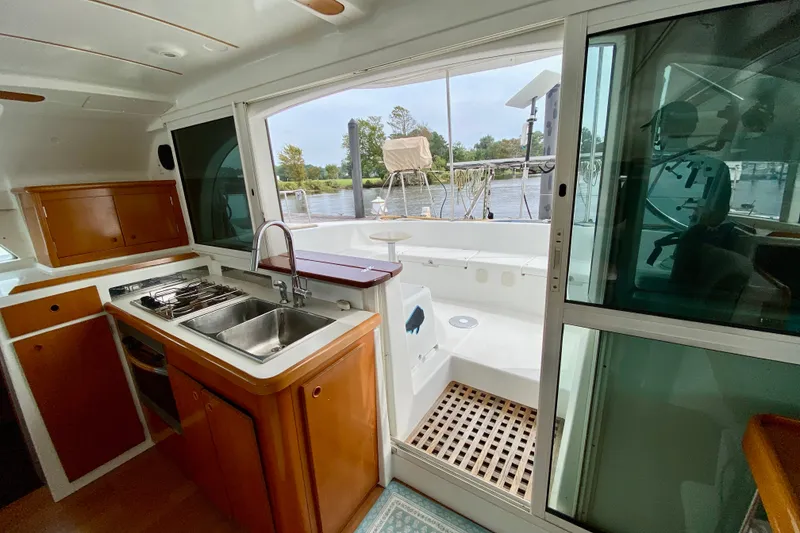 Slide: The Image of Interior view of 2005 Lagoon 380 S2 yacht kitchen with outdoor access. - 62