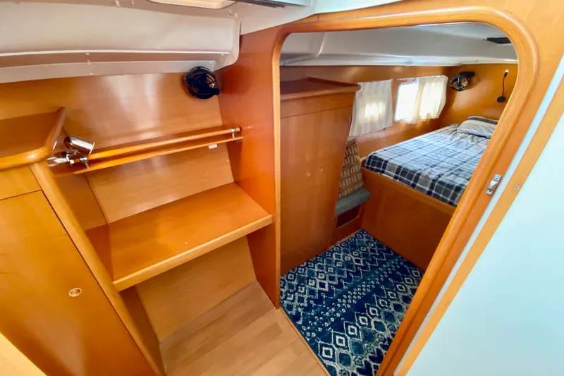 Slide: The Image of Interior of 2005 Lagoon 380 S2 yacht cabin with wooden finish and cozy bed. - 68