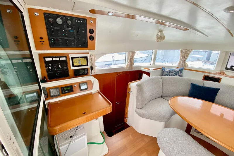 Slide: The Image of Interior of 2005 Lagoon 380 S2 yacht with navigation panel and cozy seating area. - 45