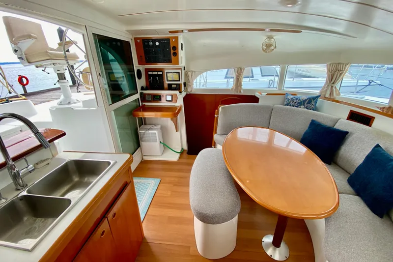 Slide: The Image of Interior of 2005 Lagoon 380 S2 yacht with cozy seating and modern kitchen area. - 81