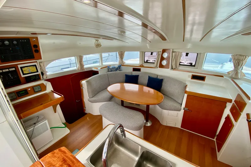 Slide: The Image of Interior of 2005 Lagoon 380 S2 catamaran with cozy seating and navigation area. - 55