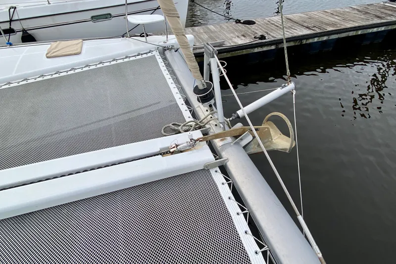 Slide: The Image of Catamaran Lagoon 380 S2 (2005) with netting and anchor at dockside. - 17