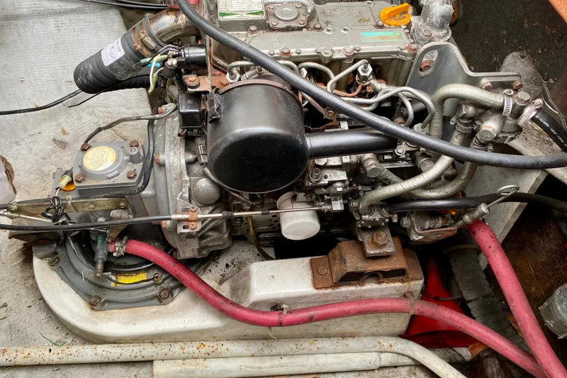 Slide: The Image of Engine compartment of a 2005 Lagoon 380 S2 catamaran, showcasing mechanical components and wiring. - 99