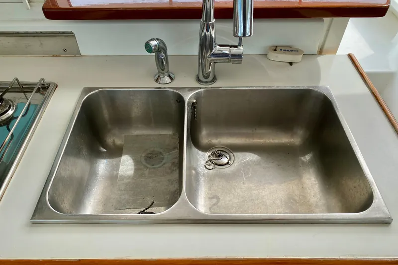 Slide: The Image of Stainless steel double sink on a 2005 Lagoon 380 S2 catamaran kitchen. - 124