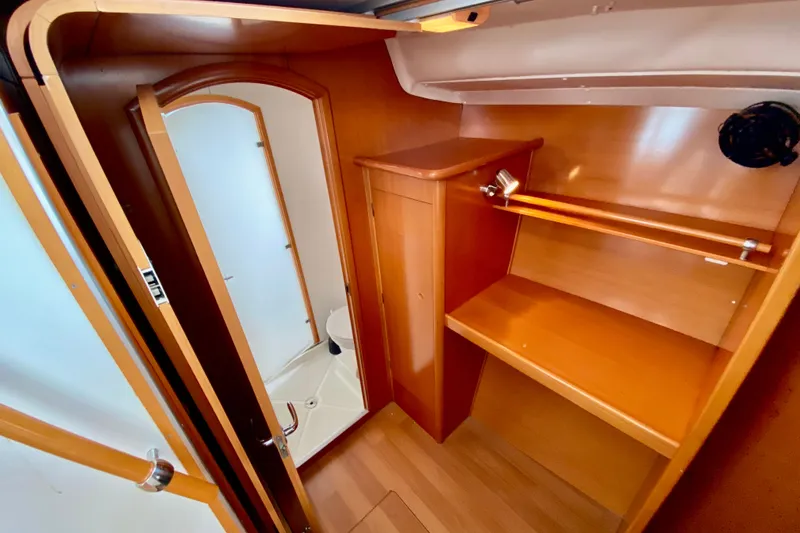 Slide: The Image of Interior of 2005 Lagoon 380 S2 yacht featuring wooden cabinetry and compact bathroom. - 69