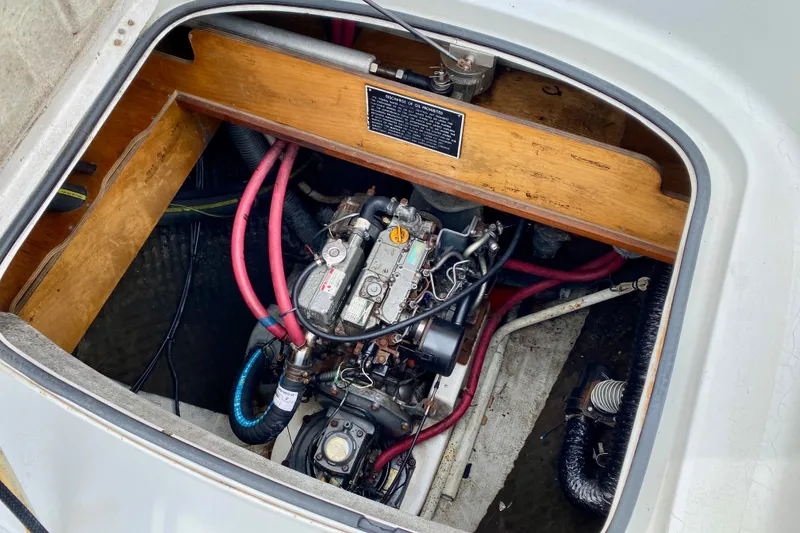 Slide: The Image of Engine compartment of a 2005 Lagoon 380 S2 sailboat, showcasing mechanical components and wiring. - 97