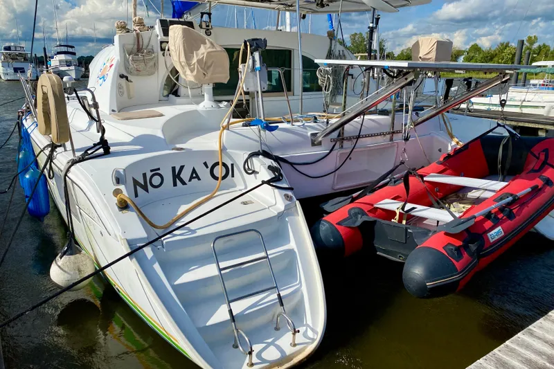 Slide: The Image of Catamaran Lagoon 380 S2, 2005 model, docked with inflatable boat, sunny day. - 5