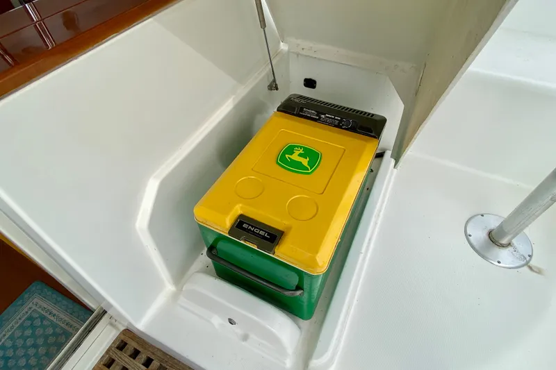 Slide: The Image of Engel cooler with John Deere logo on Lagoon 380 S2, 2005 model boat interior. - 149
