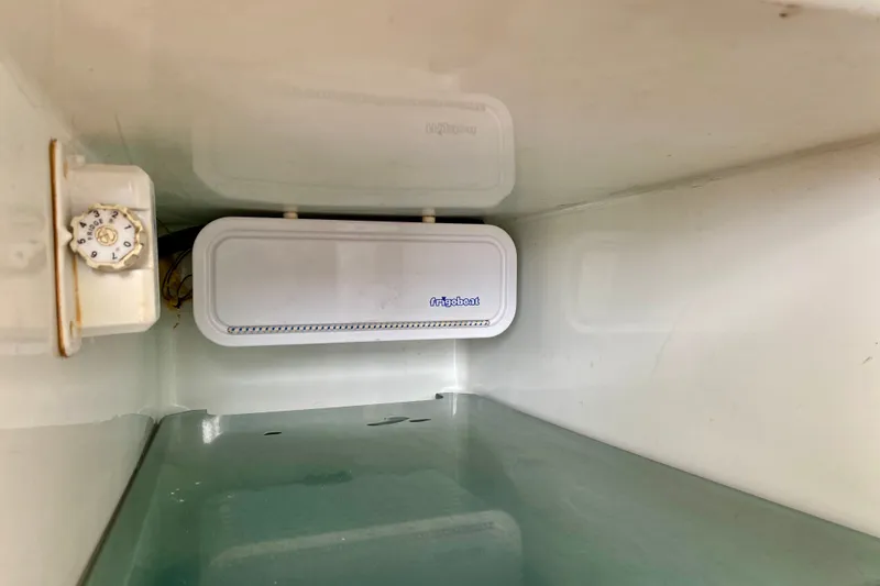 Slide: The Image of Interior of a 2005 Lagoon 380 S2 boat fridge with temperature control knob. - 133