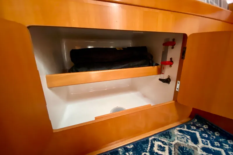 Slide: The Image of Interior storage compartment of a 2005 Lagoon 380 S2 yacht with wooden finish. - 110