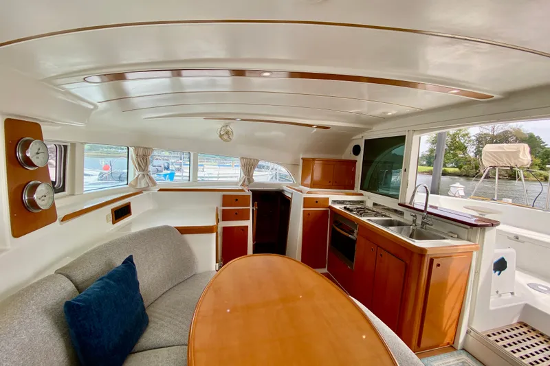 Slide: The Image of Interior of 2005 Lagoon 380 S2 catamaran with kitchen, dining area, and panoramic windows. - 61